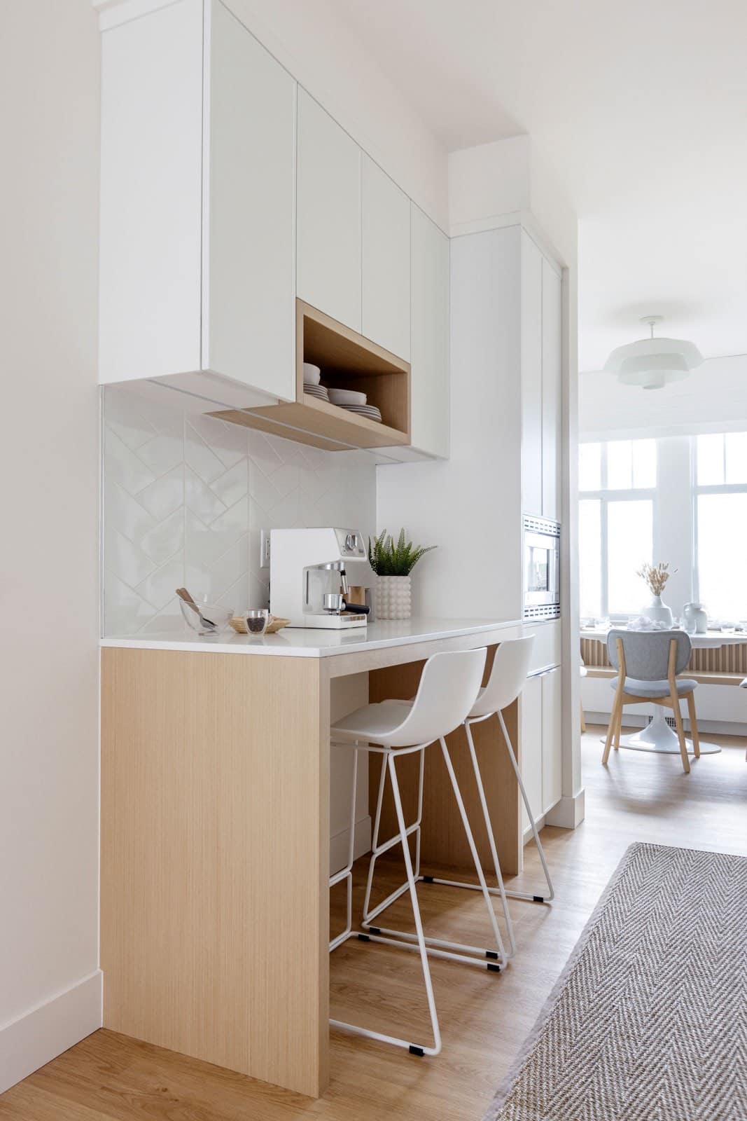 Kitchen sink with white tile backsplash and chrome faucet at The Loop South Surrey