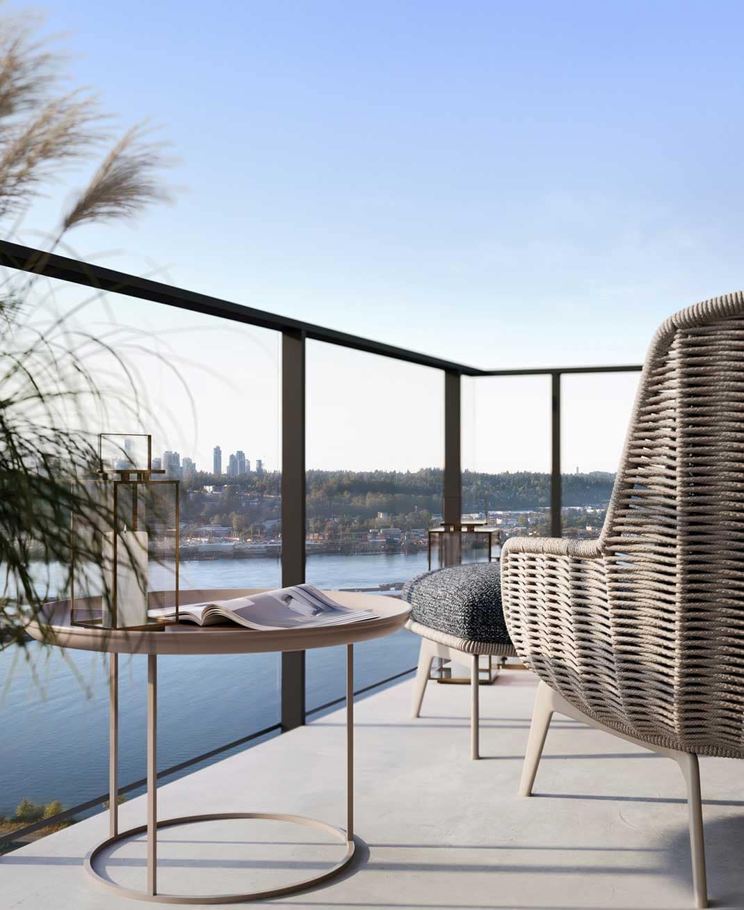 Private balcony at Encore Coquitlam with outdoor seating and expansive views overlooking the Fraser River and surrounding neighbourhoods from Beedie Living's waterfront tower.