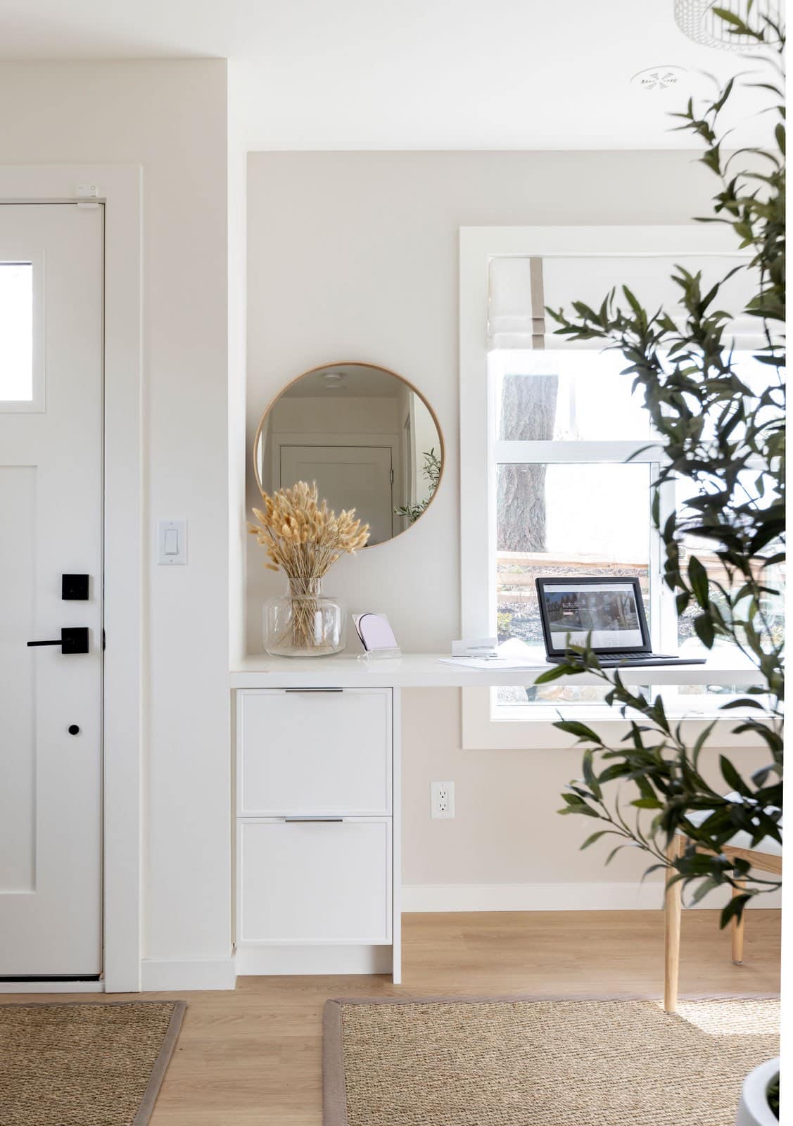 Entryway with round mirror and console table at The Loop South Surrey