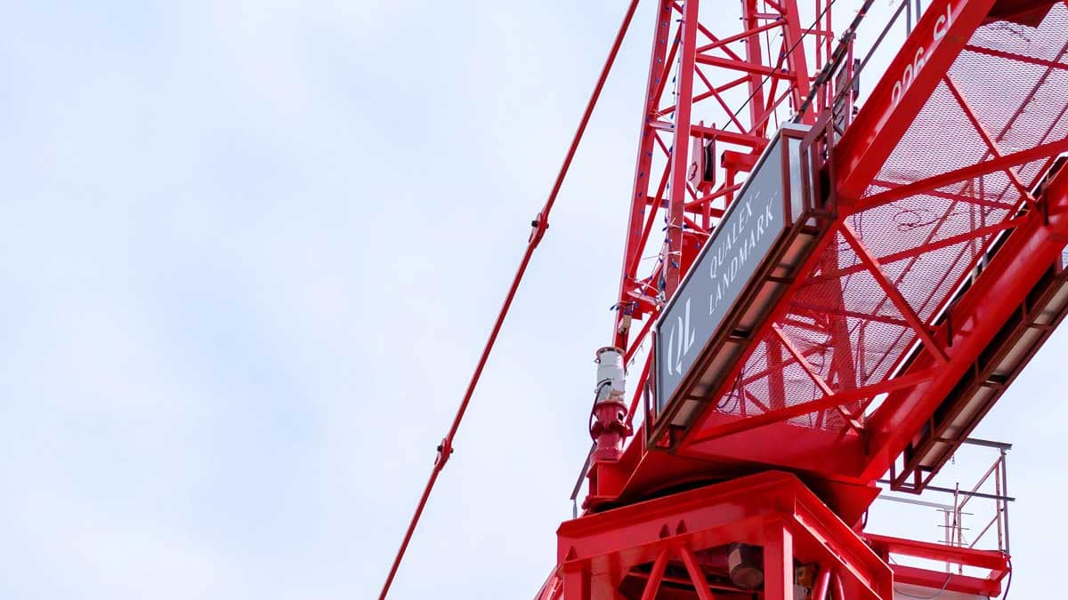 Red construction crane used to illustrate a presale condo buying guide for BC in 2025 and 2026