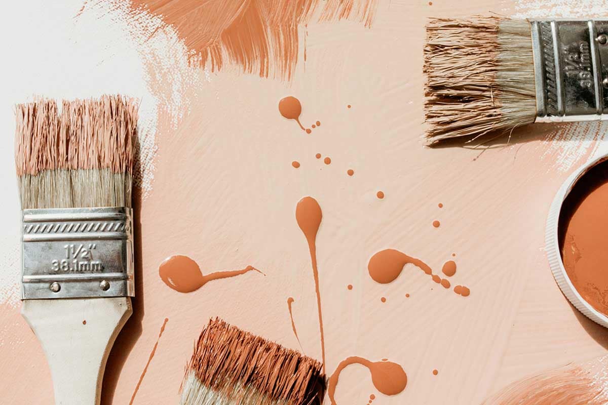 Wall with paint brushes dipped in various colors of paint, symbolizing a reliable network of home service professionals dedicated to home preparation and improvement.