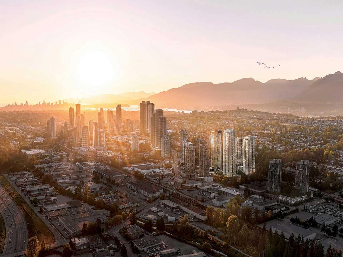 Aerial skyline view of Burnaby featuring high-rise residential towers, urban neighbourhoods, and mountain backdrops at sunset, representing Burnaby presale condos and Burnaby new construction homes for sale.