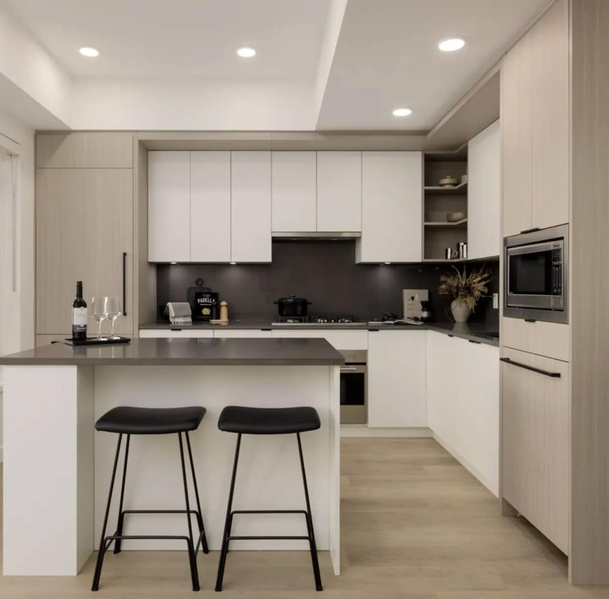 Designer kitchen interior at Linx East Vancouver with integrated appliances, sleek cabinetry, large island seating, and modern finishes at 2268 East Broadway by Lotus Capital and Omicron.