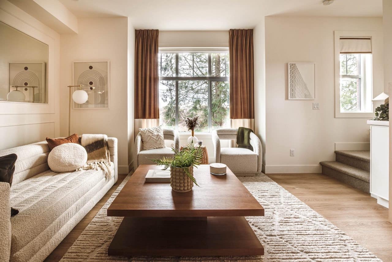 Living room with modern neutral decor and wood coffee table at The Loop South Surrey