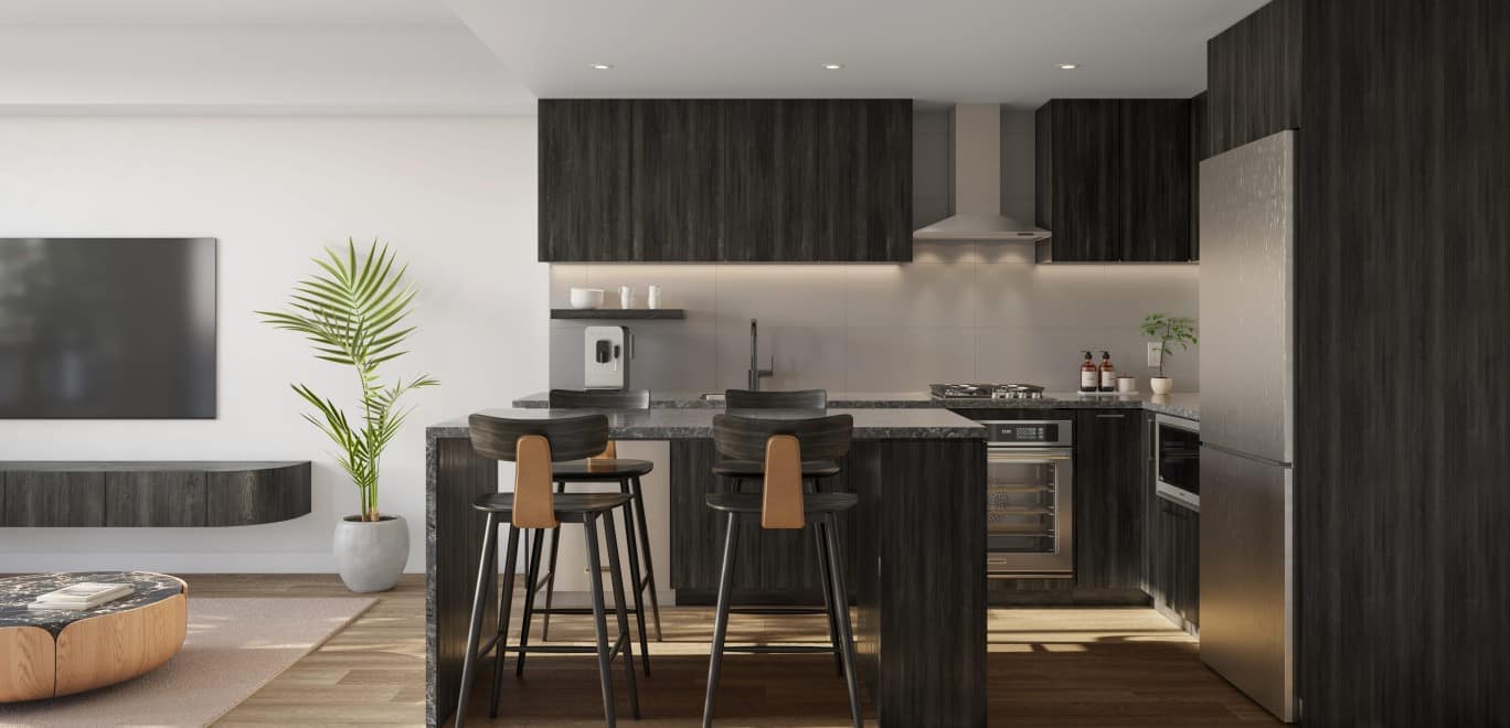 Dusk colour scheme kitchen at Alma Kelowna with dark cabinetry, island seating and integrated appliances.