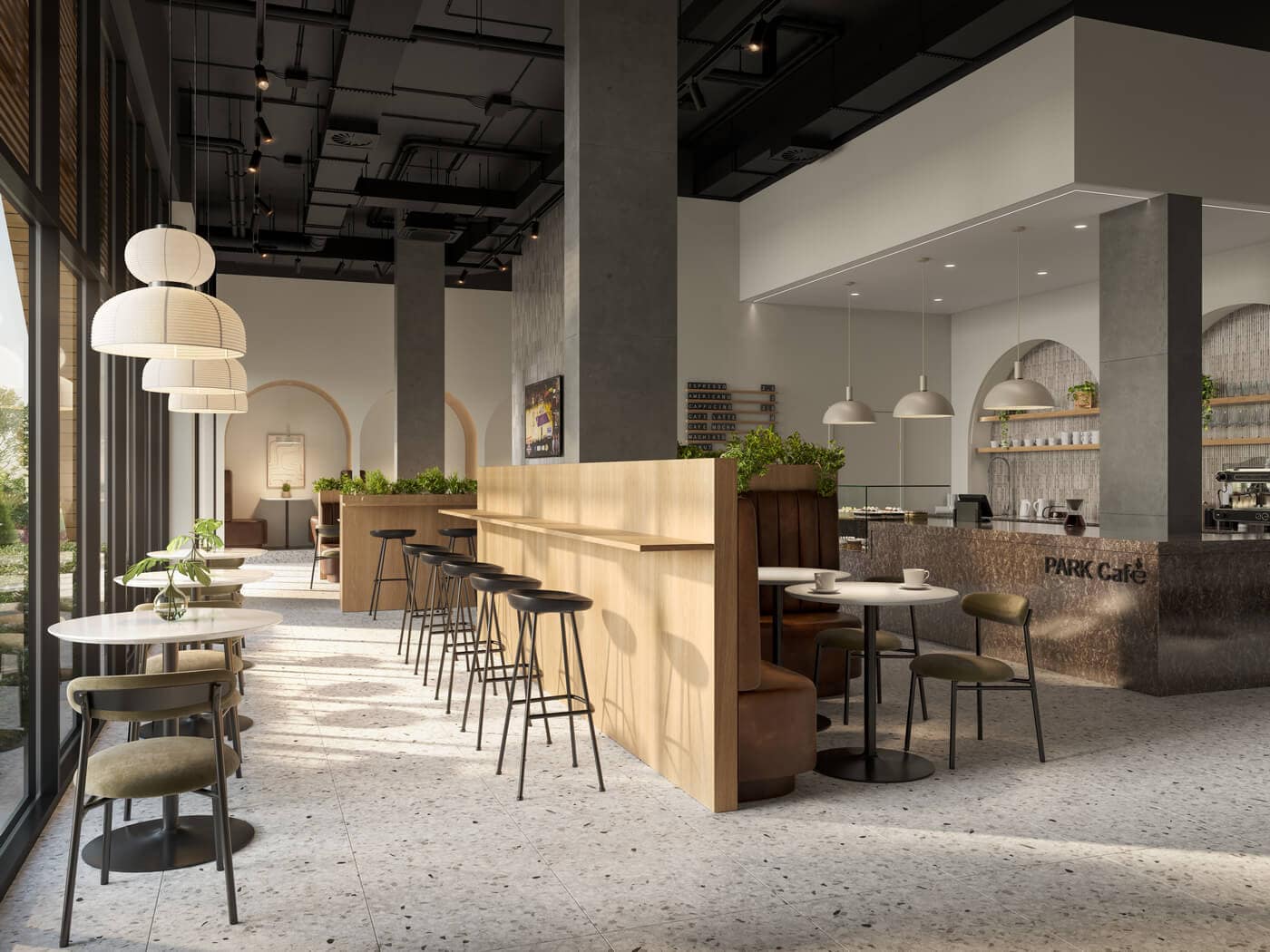 Cafรฉ-style resident amenity space at Jericho Park Langley by Essence Properties featuring lounge seating, bar seating, large windows, and modern interior finishes at 19925 78B Avenue.