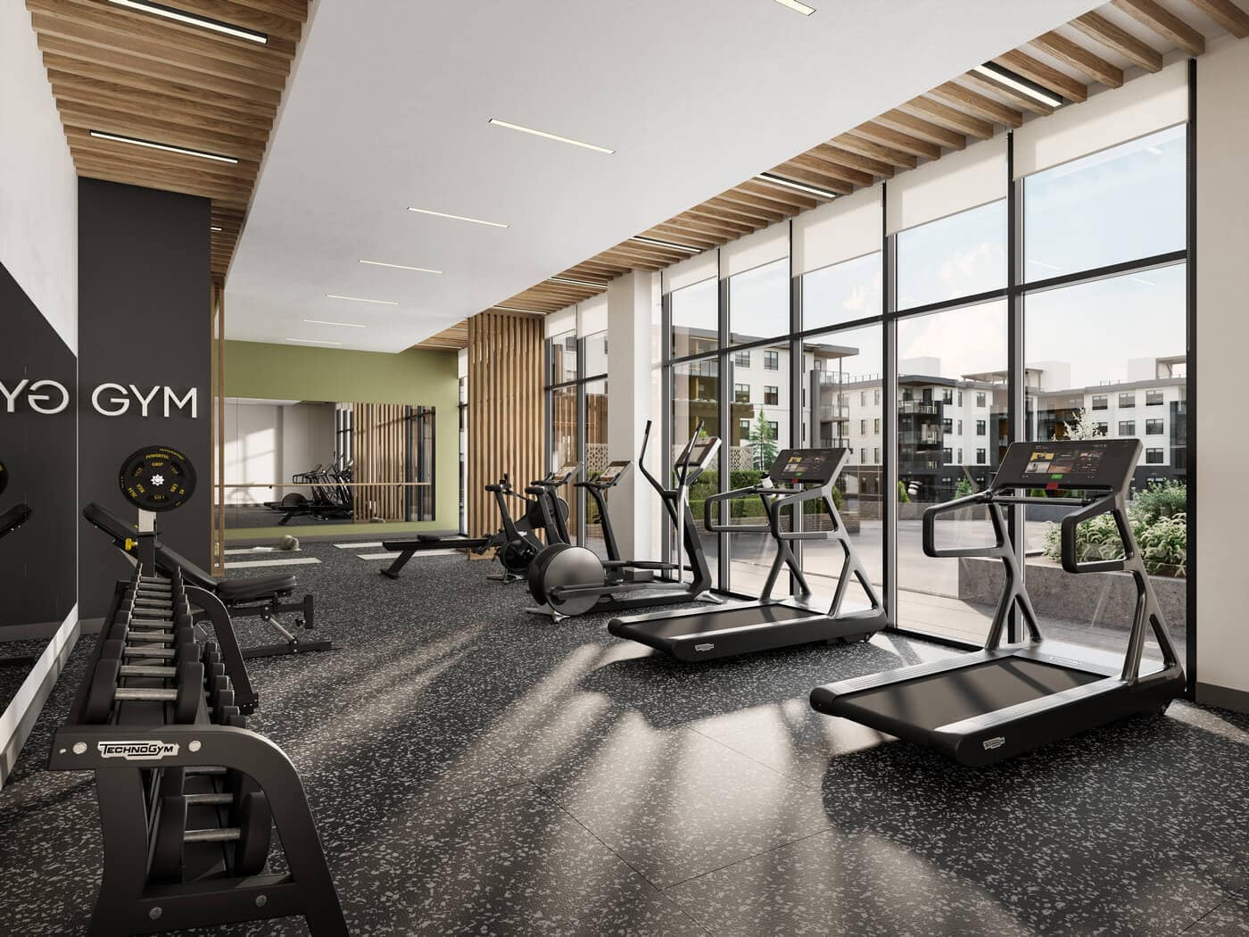 Modern fitness centre at Jericho Park Langley by Essence Properties featuring treadmills, strength equipment, floor-to-ceiling windows, and contemporary gym design at 19925 78B Avenue.