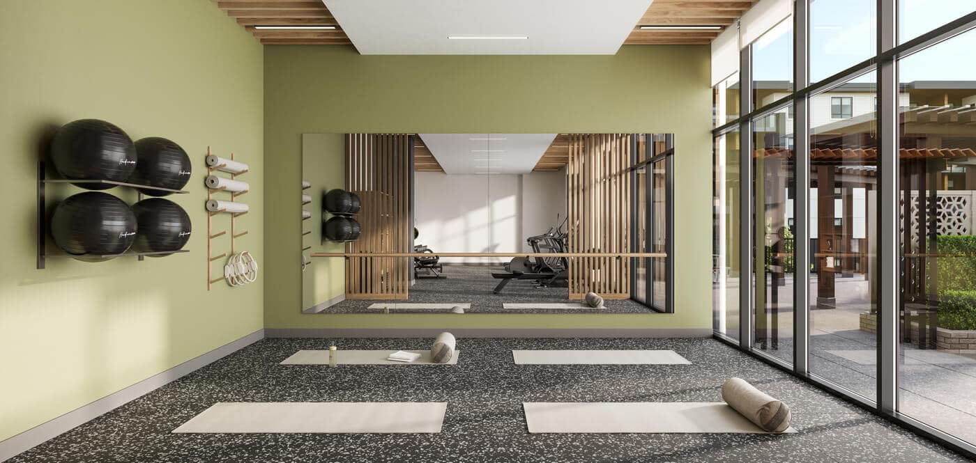 Fitness and yoga studio at Jericho Park Langley by Essence Properties featuring exercise mats, mirrored walls, natural light, and wellness-focused amenities at 19925 78B Avenue.