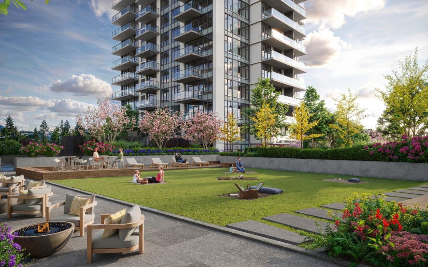 Landscaped outdoor courtyard at Pine & Glen Coquitlam by Onni Group, featuring a large central lawn, lounge seating, fire pit area, flowering gardens, and tower residences at 1175 Pinetree Way in Coquitlam City Centre.
