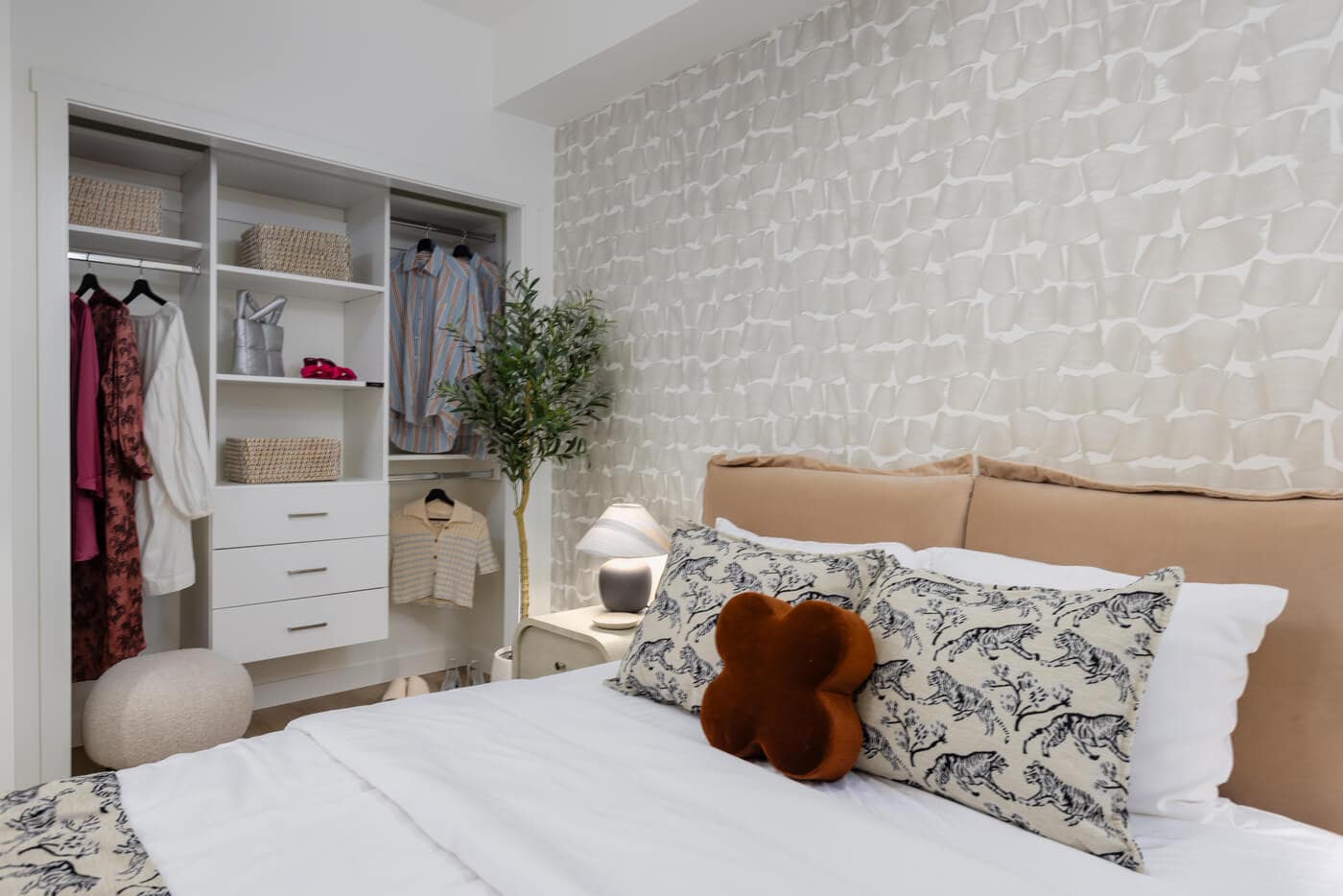 Bedroom with integrated closet storage at Jericho Park Langley by Essence Properties featuring custom shelving, modern furnishings, and contemporary finishes at 19925 78B Avenue.