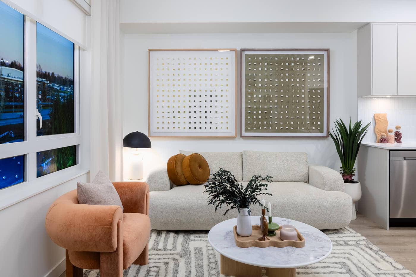Living room interior at Jericho Park Langley by Essence Properties featuring modern furnishings, large windows, soft neutral tones, and open-concept design at 19925 78B Avenue.