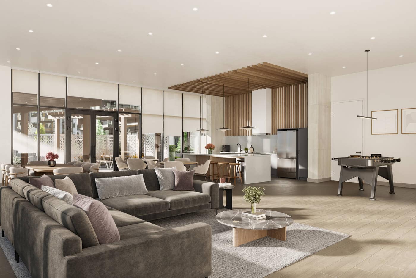 Resident lounge and entertainment space at Jericho Park Langley by Essence Properties featuring seating areas, kitchen space, games table, and contemporary interior design at 19925 78B Avenue.