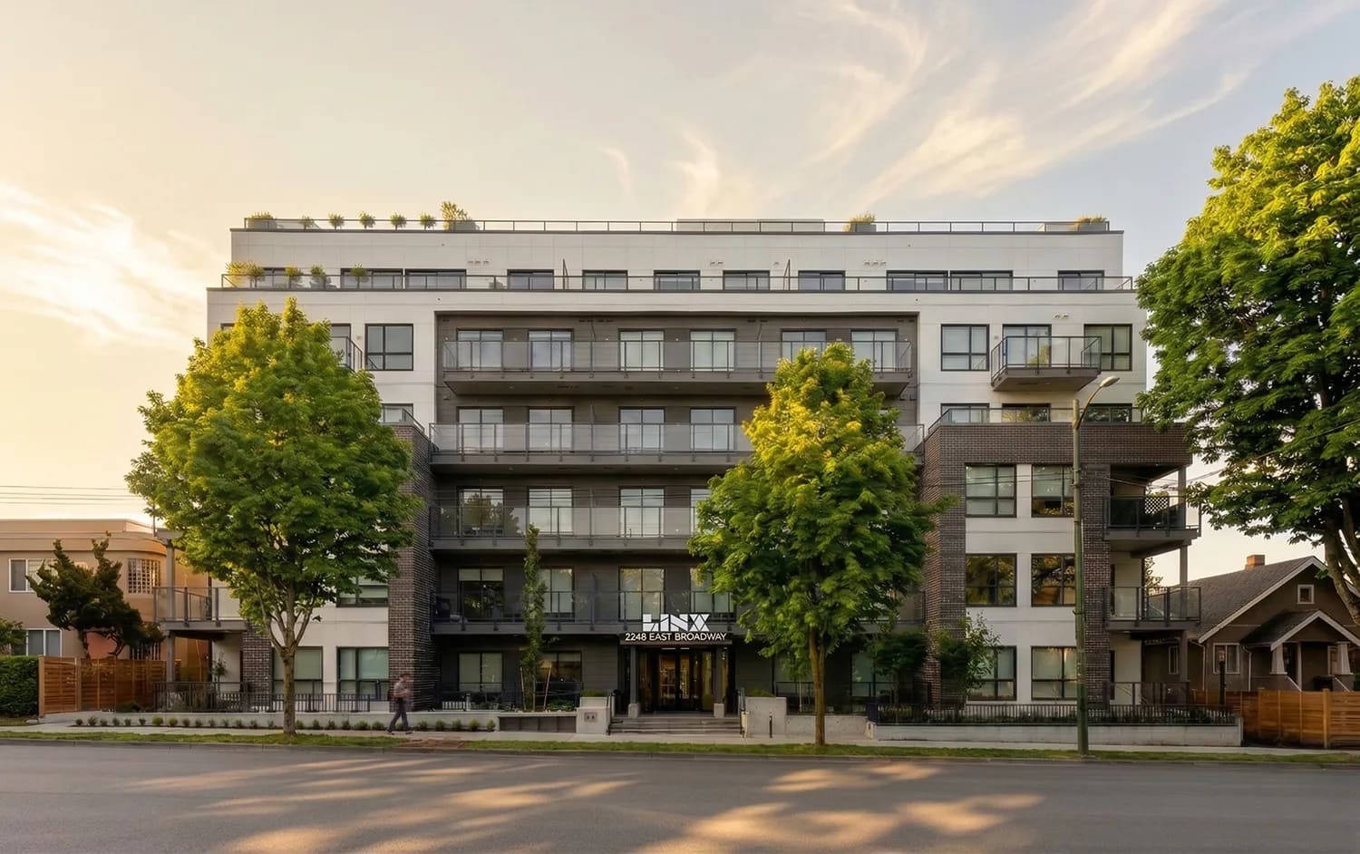 Street-level exterior view of the Linx presale development at 2268 East Broadway in East Vancouver by Lotus Capital and Omicron featuring modern architecture, landscaped frontage, and contemporary balconies.