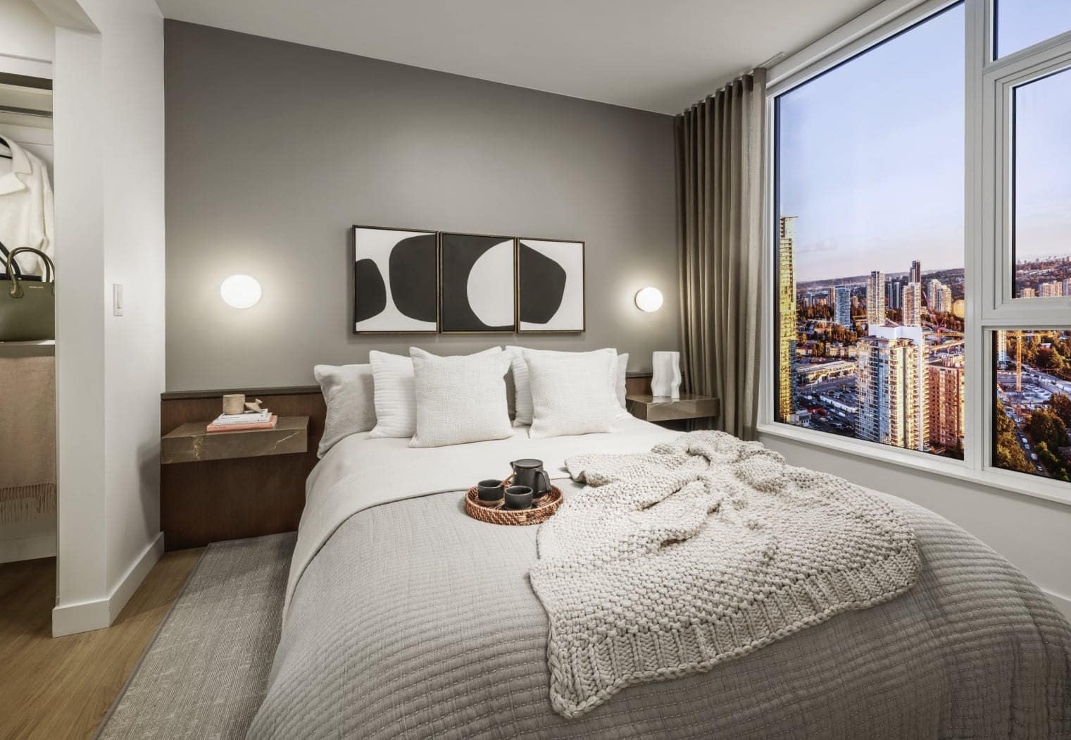 Bedroom at Gardena Coquitlam by Intracorp located at 635 Gardena Drive in Burquitlam, featuring soft neutral tones, large windows with city views, modern lighting, and a cozy, thoughtfully designed sleeping space.