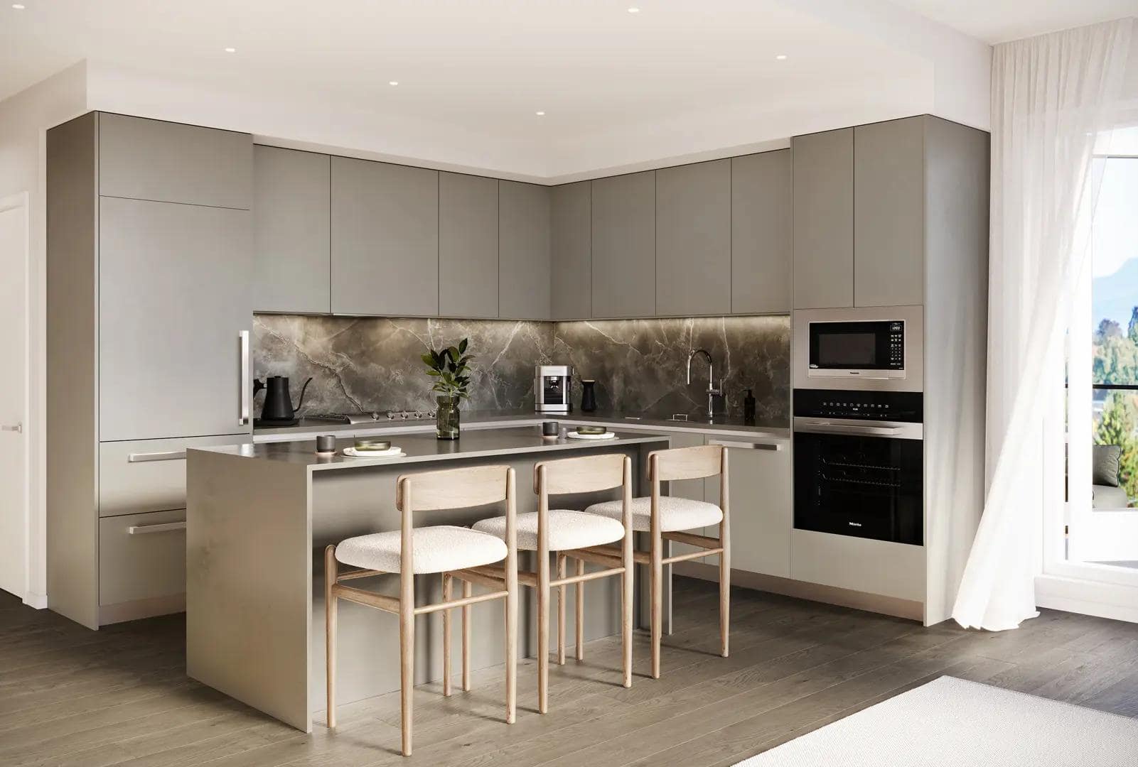 Elegant kitchen interior at Arden presale in Vancouverโs Cambie neighbourhood with grey cabinetry, stone slab backsplash, built-in wall ovens, and minimalist island seating, developed by Aria Pacific Development at 4281 Cambie Street.