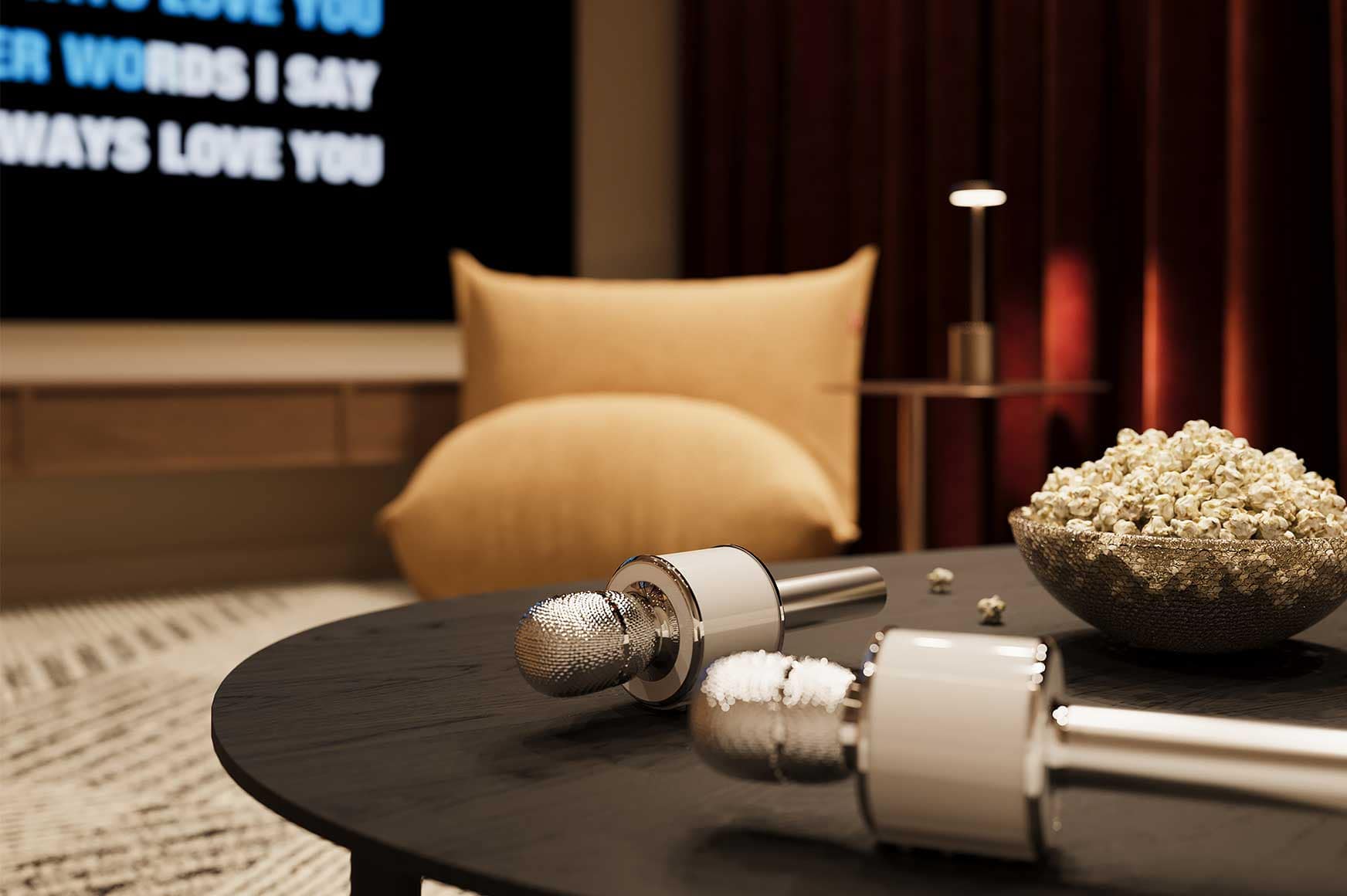 Entertainment room at Encore Coquitlam featuring karaoke microphones, media equipment, comfortable seating, and private resident gathering spaces within the Fraser Mills development.