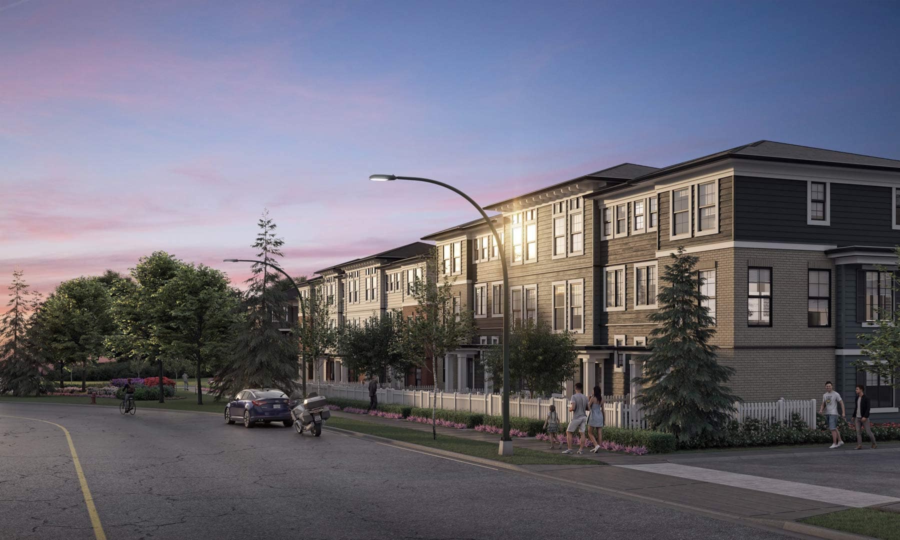 Evening streetscape of Charlton Cloverdale townhomes at 17429 59 Avenue by Warwickshire Homes, featuring warm interior lighting, tree-lined sidewalks, and a quiet residential atmosphere.