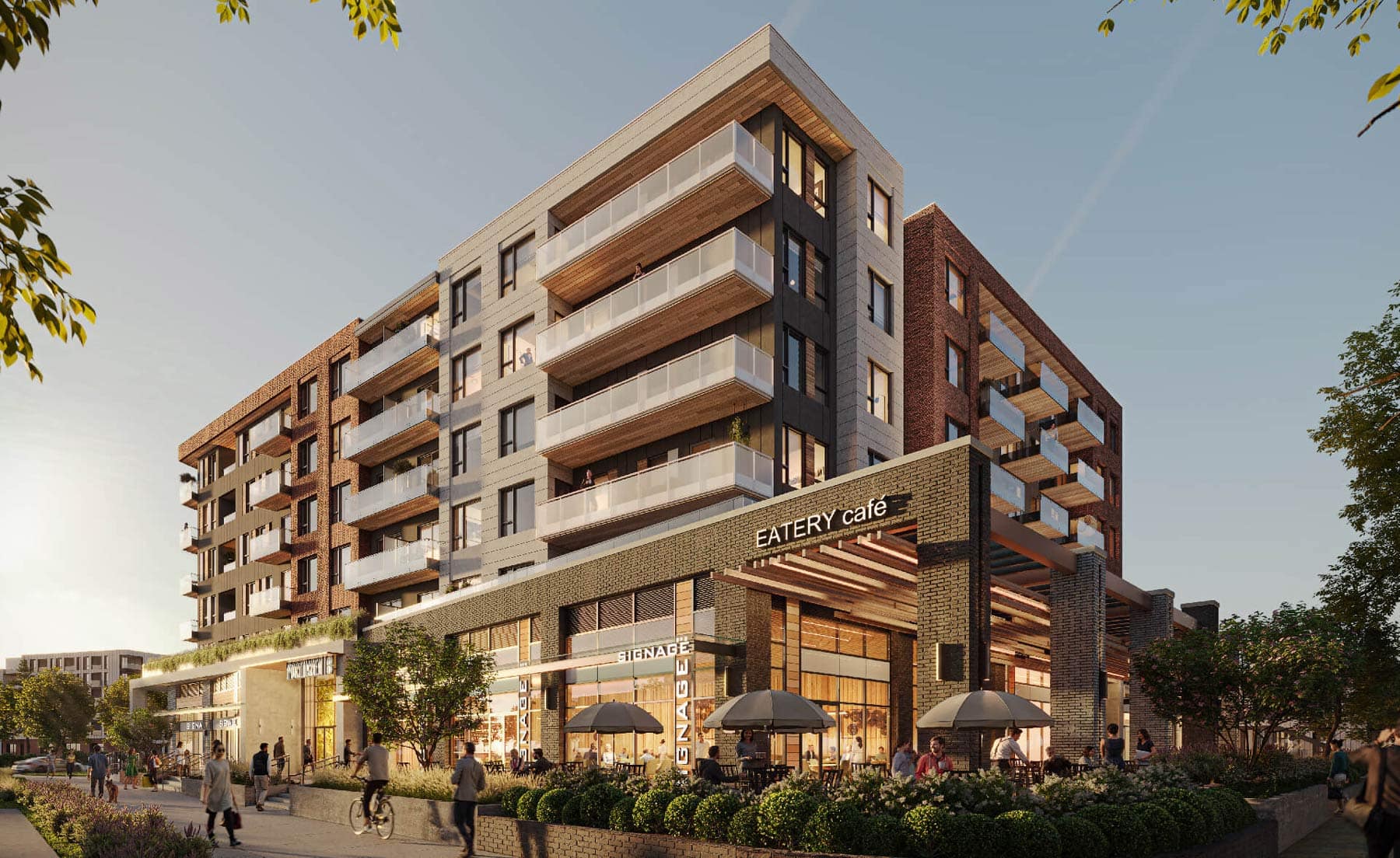 Corner view of Porthaven Port Coquitlam featuring brick and modern facade, retail storefronts, patios, and pedestrian-friendly streetscape by Northstar Development.