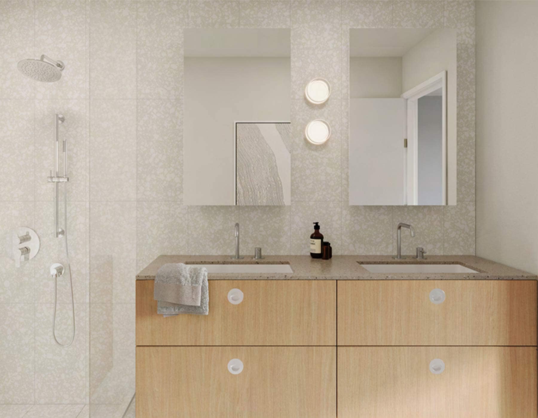 Vanity detail at Hem Vancouver showing wood cabinetry, dual sinks, round lighting fixtures, and textured tile finishes by Hudson at 385 Lakewood Drive