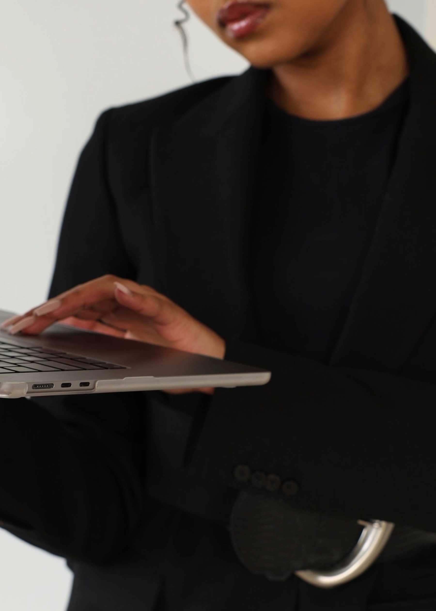 Professional using laptop to access real estate and mortgage calculators