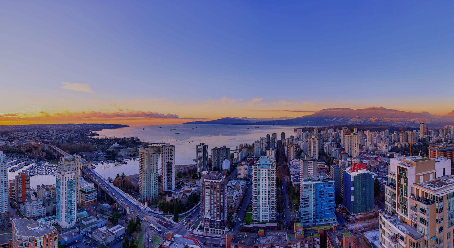 Panoramic skyline and ocean views from 1535 Howe Vancouver overlooking English Bay, Downtown Vancouver high-rises, False Creek, and the North Shore Mountains from residences at 1335 Howe Street.