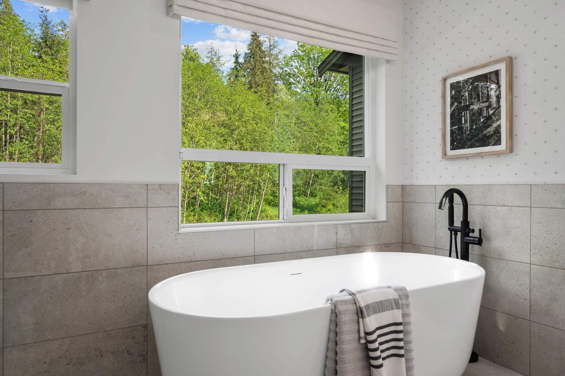 Bathroom at Haven Maple Ridge by Epic Homes at 11205 250B Street featuring freestanding tub, large window, and modern fixtures