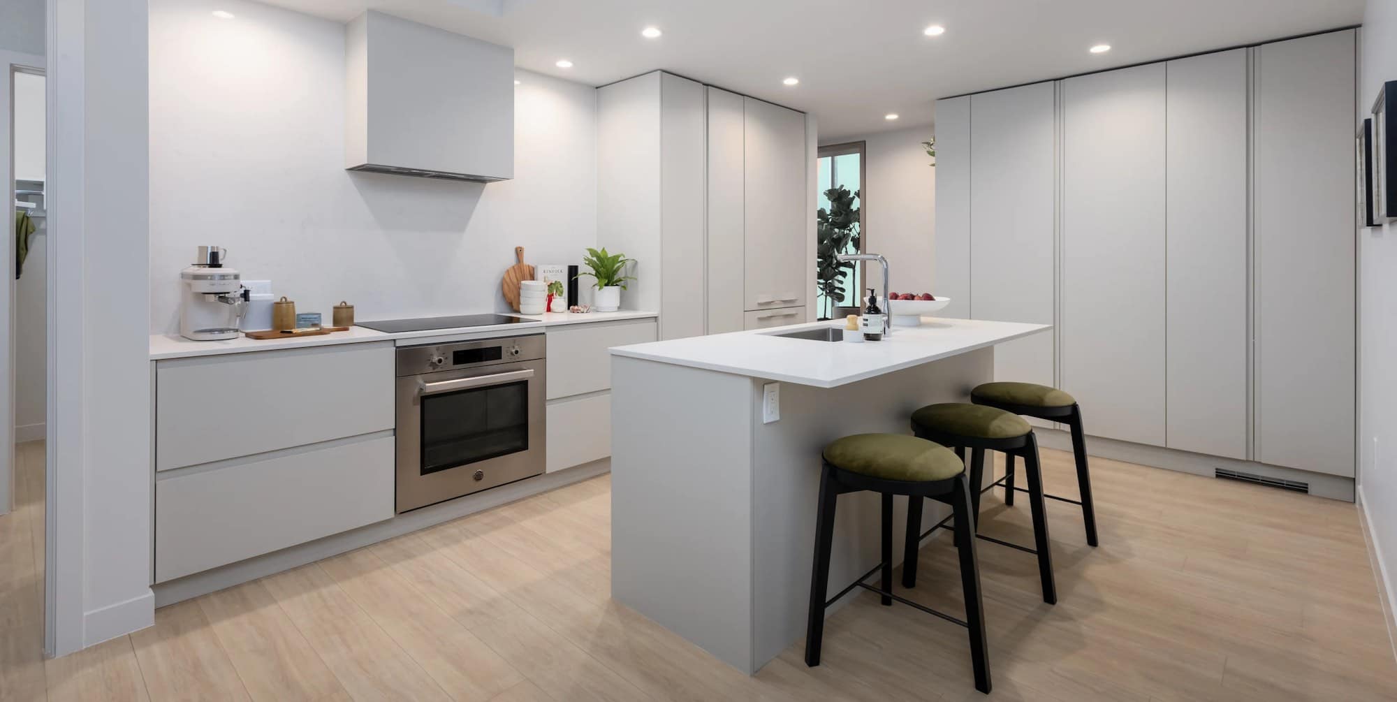 Modern kitchen with island seating and integrated appliances at Ironwood Coquitlam condos