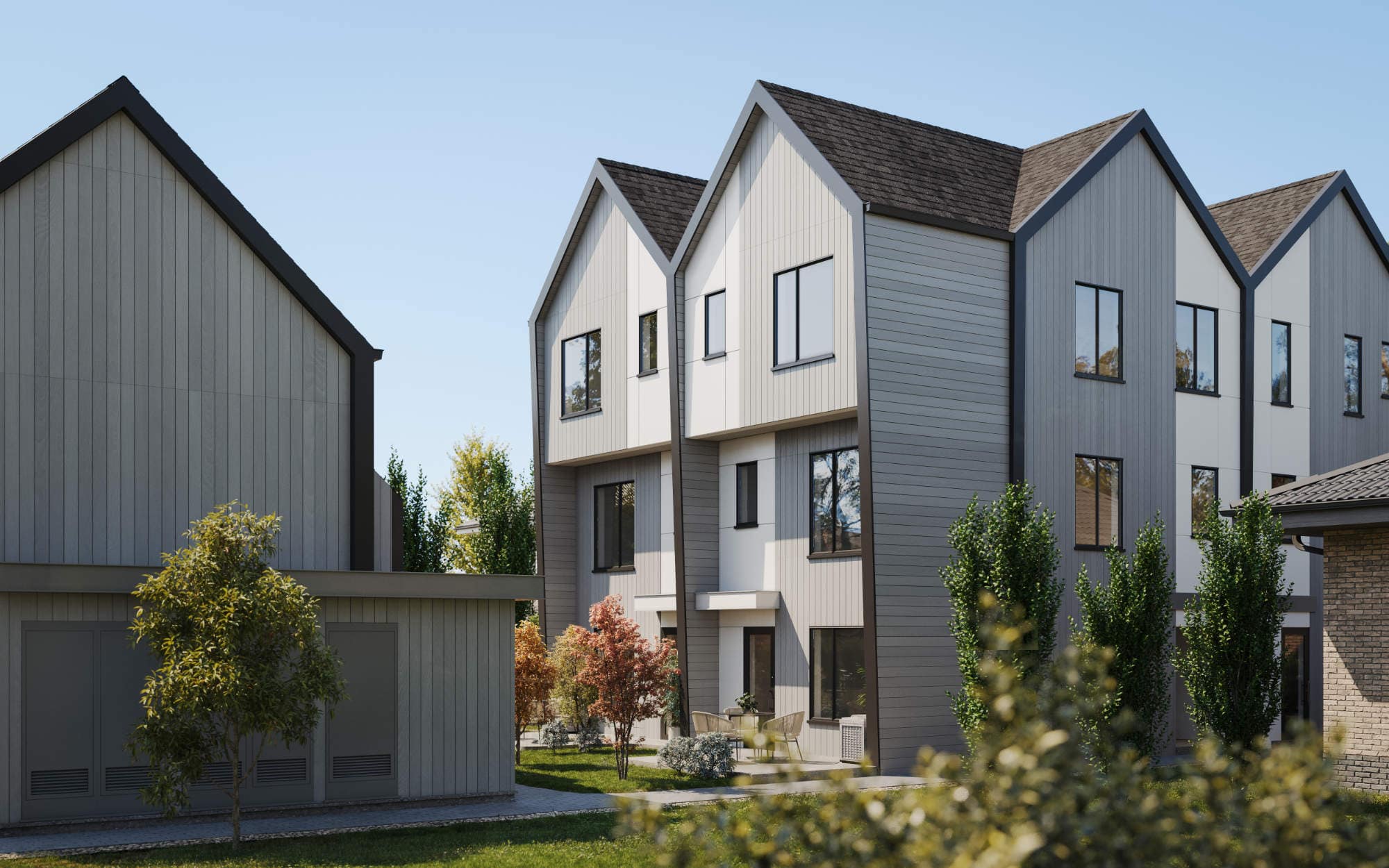 Modern townhome exterior at Quintet Vancouver East showcasing pitched rooflines, vertical siding, large windows, and West Coastโinspired architecture by THT Properties in Vancouver East.