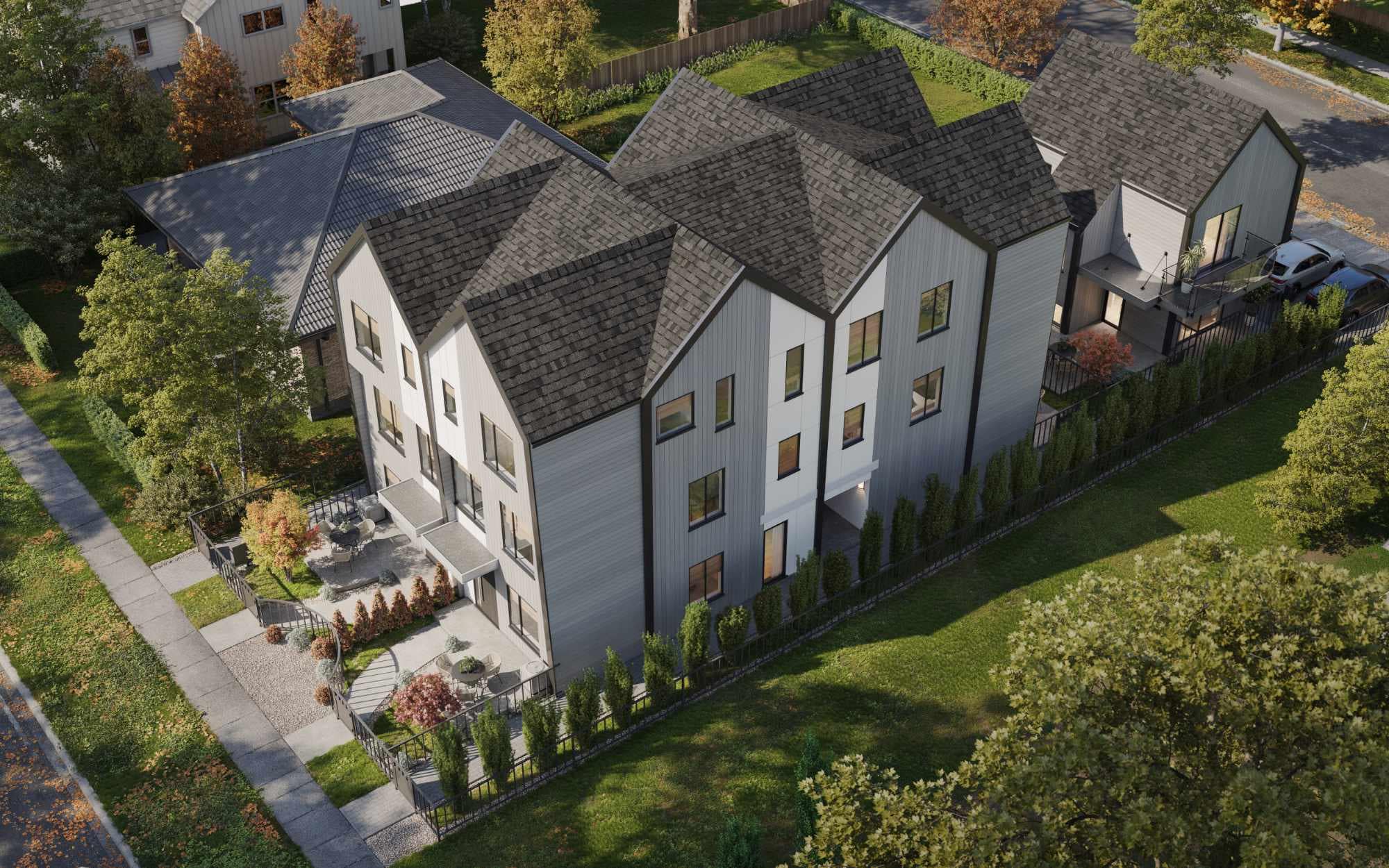 Aerial view of Quintet Vancouver East showing five modern townhomes with pitched roofs, landscaped pathways, and private outdoor spaces developed by THT Properties in Vancouver East.