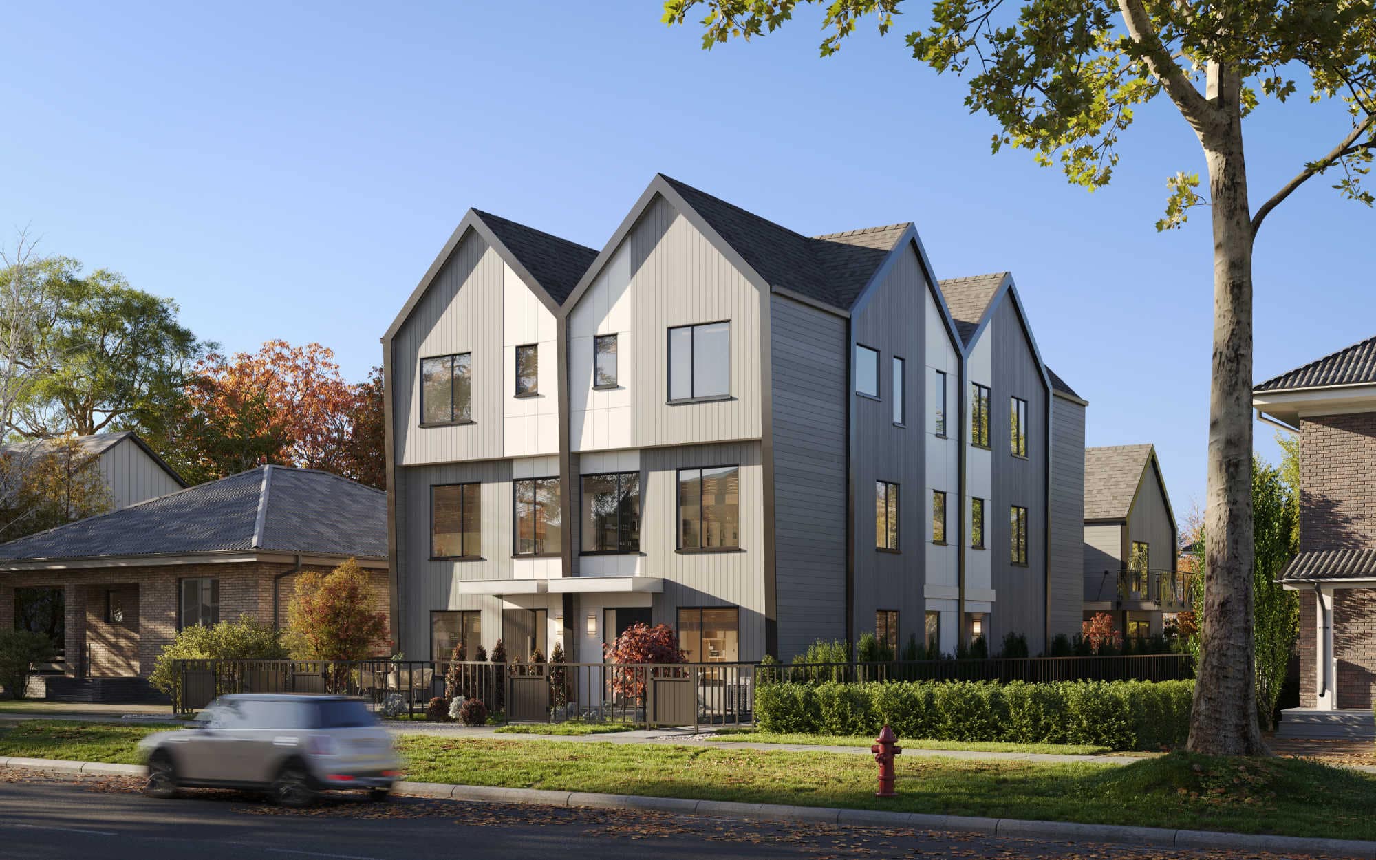Street-level view of Quintet Vancouver East townhomes at 2240 East 40th Avenue, featuring modern West Coast architecture, pitched rooflines, and landscaped frontage by THT Properties.