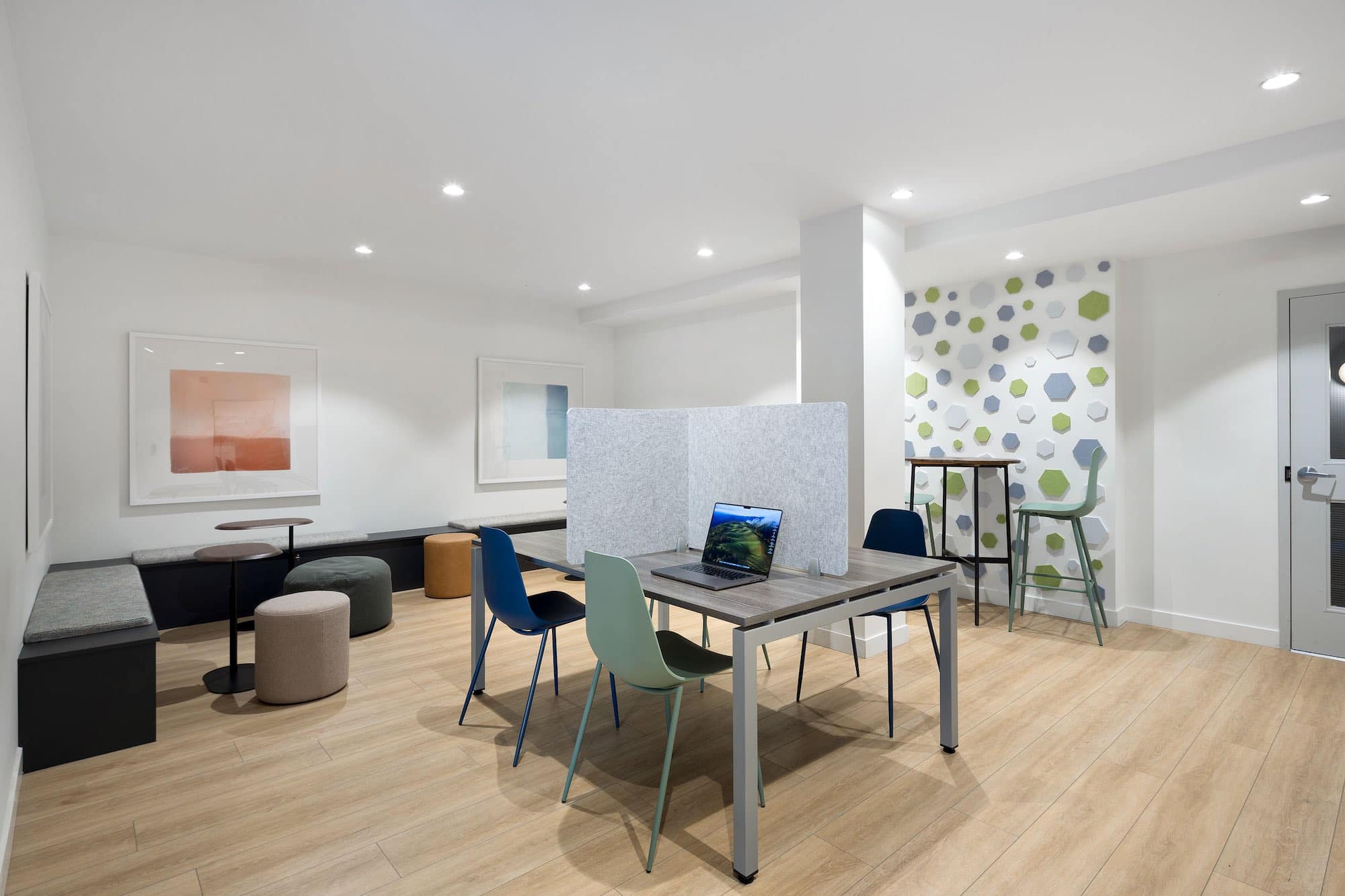 Co-working lounge amenity inside Bastille presale development by Porte Homes in Coquitlam’s Maillardville neighbourhood featuring work tables, seating areas, modern lighting, and flexible workspace designed for residents at 209 Lebleu Street.
