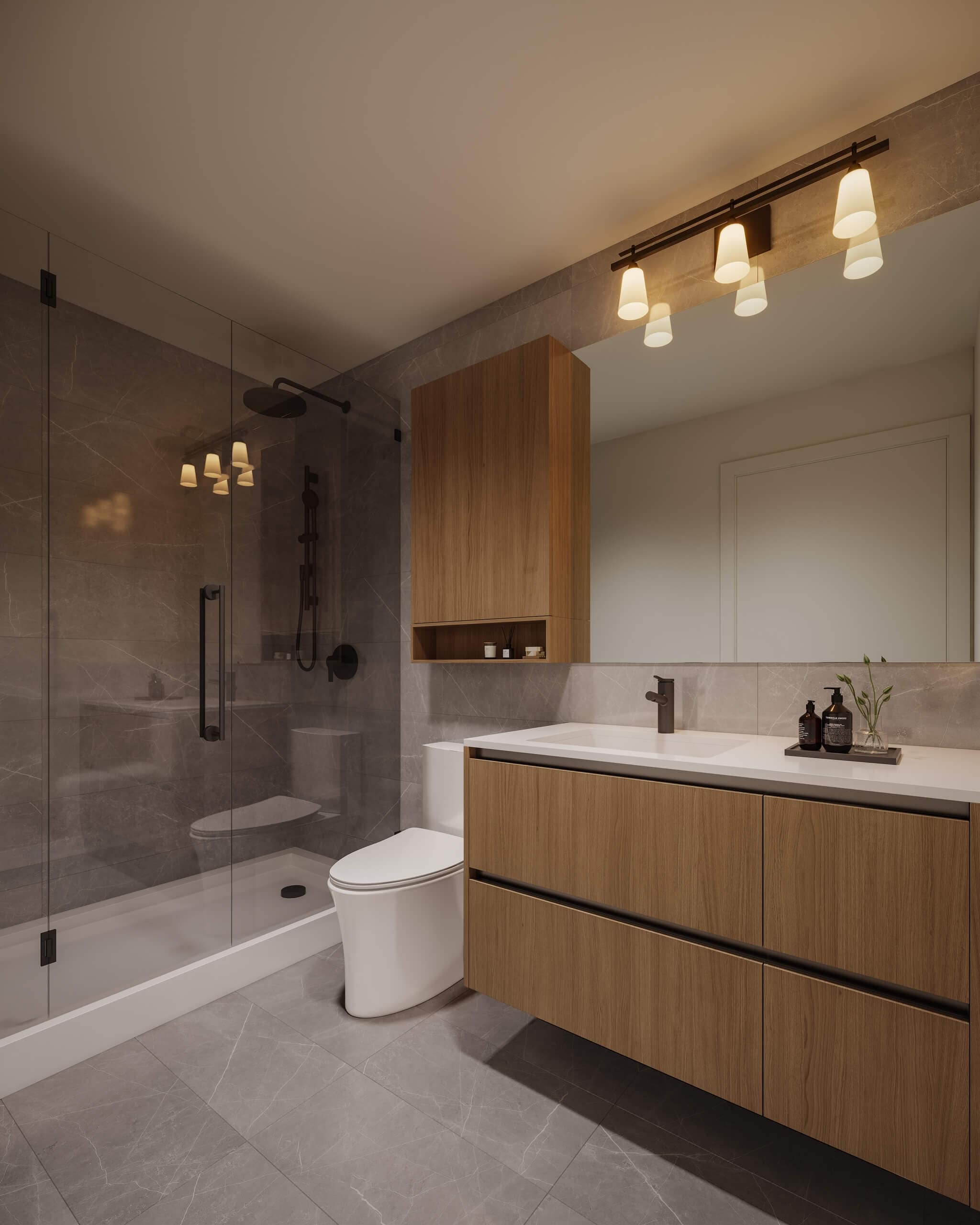 Spa-inspired bathroom at Centrale Burnaby featuring a frameless glass shower, floating vanity, stone tile finishes, matte black fixtures, and modern lighting by FirstTrack Development in Burnaby’s Capitol Hill.