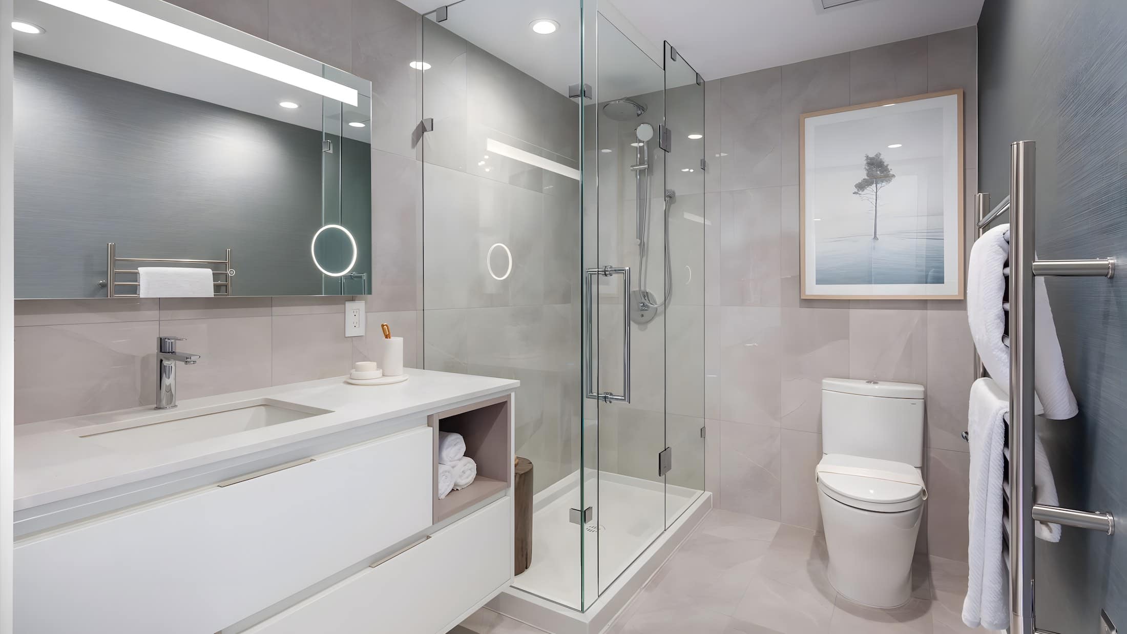 Elegant bathroom with frameless glass shower and large vanity at Artesia Metrotown Burnaby
