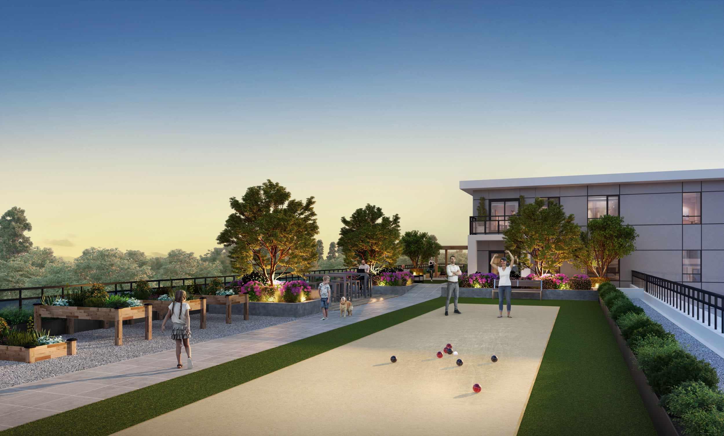 Rooftop amenity terrace at Spera presale development in Surrey Newton by Peterson Group at 8293 King George Blvd, featuring a bocce court, landscaped planters, patio seating and gathering areas, pathway lighting, and greenery along the rooftop edge, designed for resident socializing and outdoor recreation.