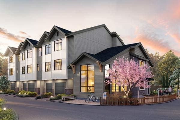 Corner perspective of Charlton Cloverdale townhomes at 17429 59 Avenue, developed by Warwickshire Homes, featuring modern three-storey homes, attached garages, landscaped sidewalks, and a blooming tree in a quiet residential Cloverdale setting.