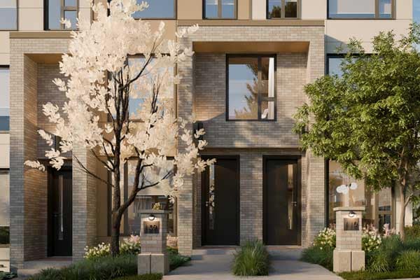 Modern townhome exterior at Harriswood Coquitlam by Domus Homes, located at 611 Harrison Avenue in Coquitlam West, featuring brick façade, private front entrances, landscaped pathway, mature trees, and contemporary architectural design in a quiet residential setting