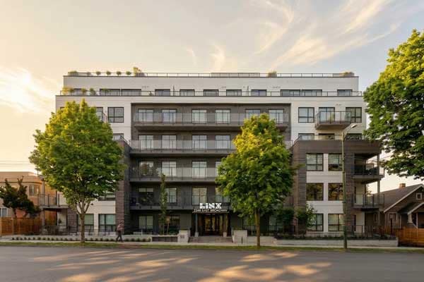 Front exterior view of the Linx presale development at 2268 East Broadway in East Vancouver by Lotus Capital and Omicron, showcasing modern condominium architecture, expansive balconies, and landscaped streetscape design.