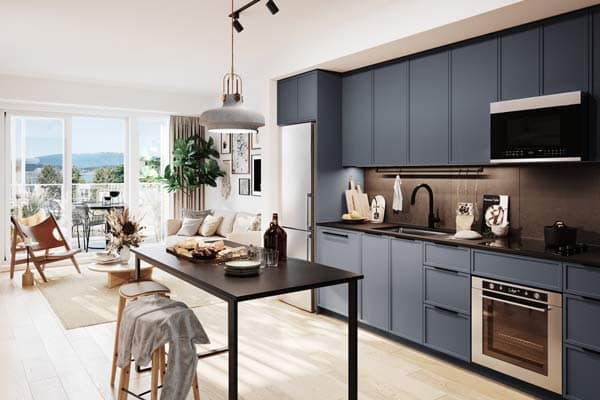 Open-concept kitchen and living area at Moody Yards Port Moody featuring blue cabinetry, island dining, and bright balcony view by Mosaic at 3015 Murray Street