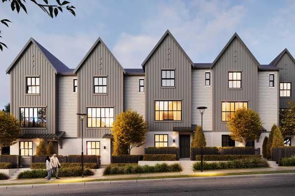Streetscape view of Renfrew South Langley presale townhomes in Willoughby Langley by CastleHill Homes at 20329 80 Avenue, displaying a row of contemporary homes with peaked rooflines, large windows, landscaped greenery, sidewalks, and a walkable residential setting designed for modern family living