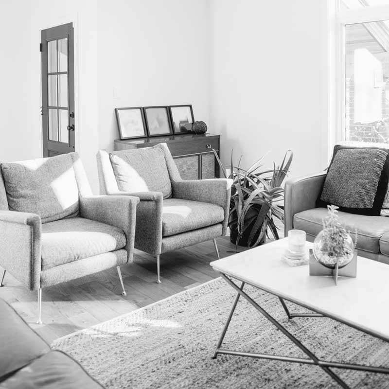 Bright rental living room with modern seating and natural light for YVR Real Estate rental marketing