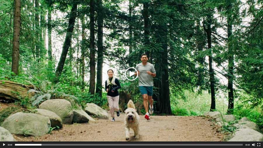 Video thumbnail showing a family jogging with their dog along a forest trail near Beaumont Burke Mountain by Polygon at 3630 Harper Road in Coquitlam, highlighting the community's close access to Burke Mountain's parks, hiking trails, and outdoor recreation.