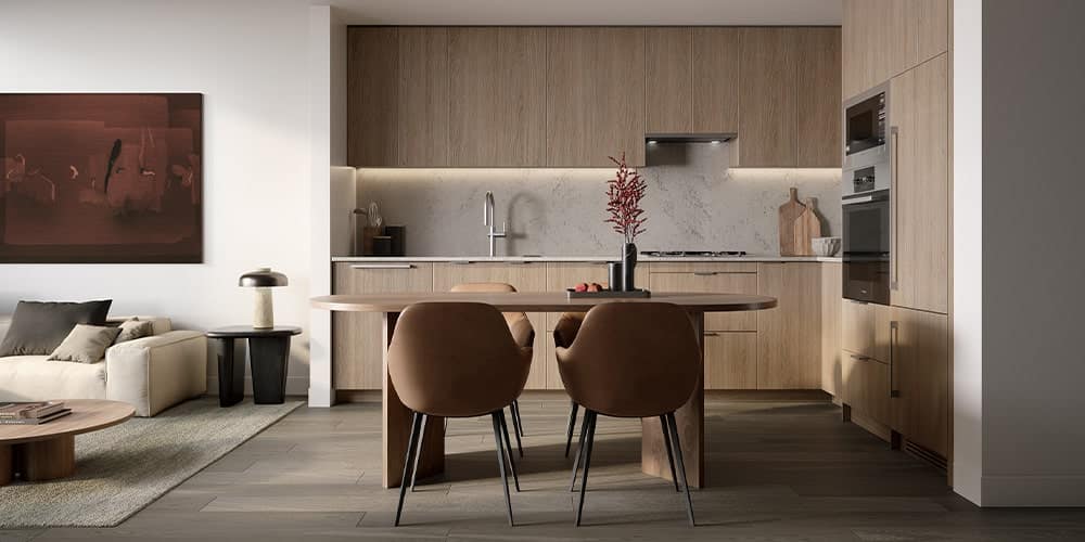 Modern light wood kitchen at Reign Metrotown with integrated appliances and dining area.