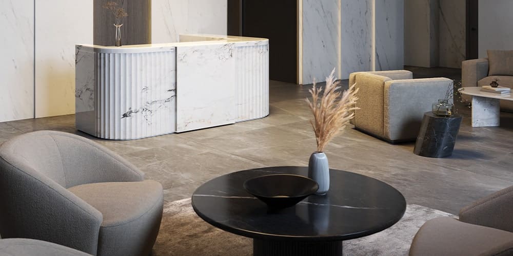 Marble reception desk and lounge seating inside the Reign Metrotown lobby by Wesgroup.