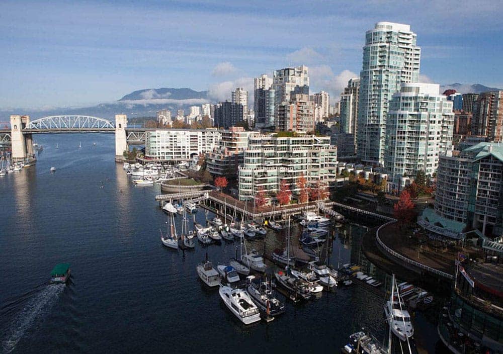 Aerial view near 1535 Howe Vancouver showcasing False Creek marinas, Granville Bridge, waterfront pathways, and Downtown Vancouver skyline surrounding 1335 Howe Street.