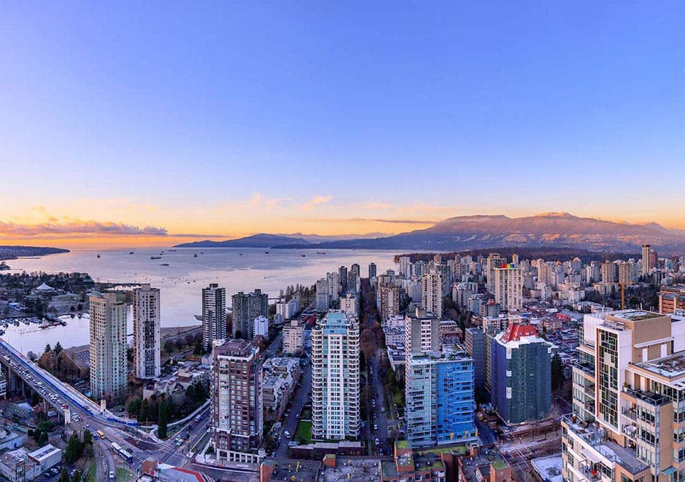 Panoramic aerial view from 1535 Howe Vancouver featuring Downtown Vancouver skyline, English Bay waterfront, and North Shore mountain scenery surrounding 1335 Howe Street.