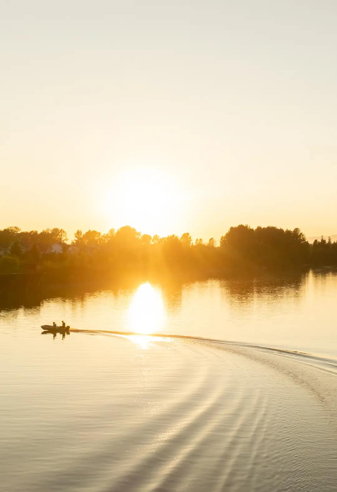 Golden sunset over calm Fraser River near Renfrew South Langley presale development by CastleHill Homes