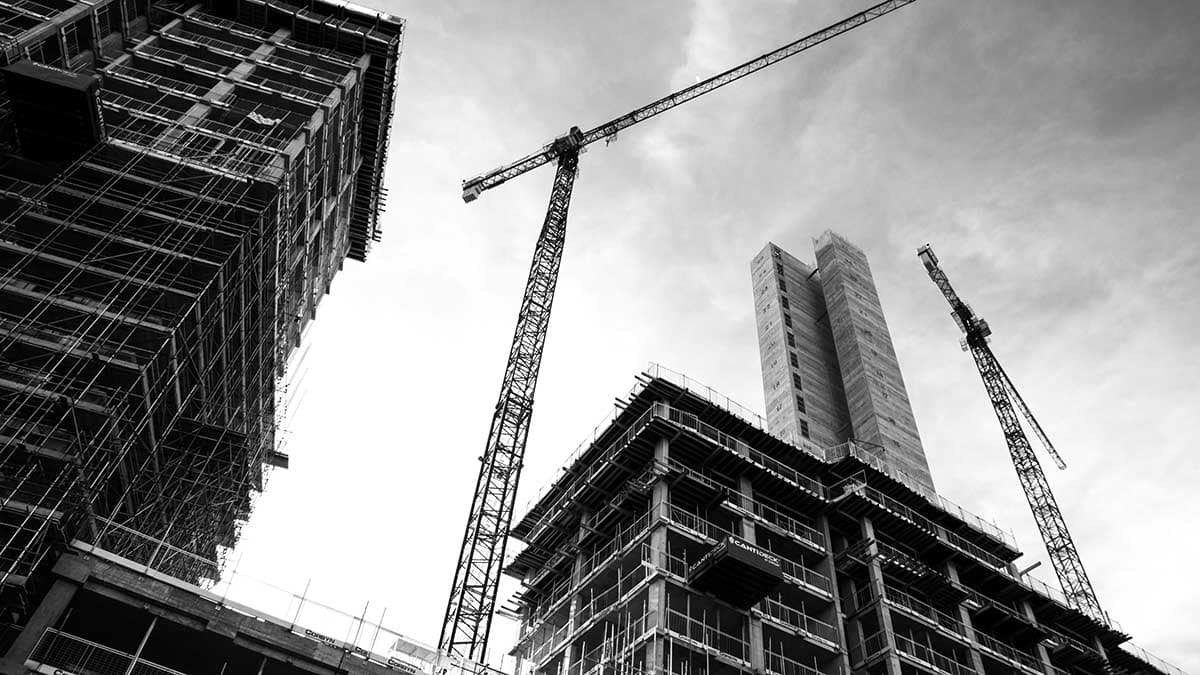 Construction cranes and concrete condo towers under development in Metro Vancouver, BC