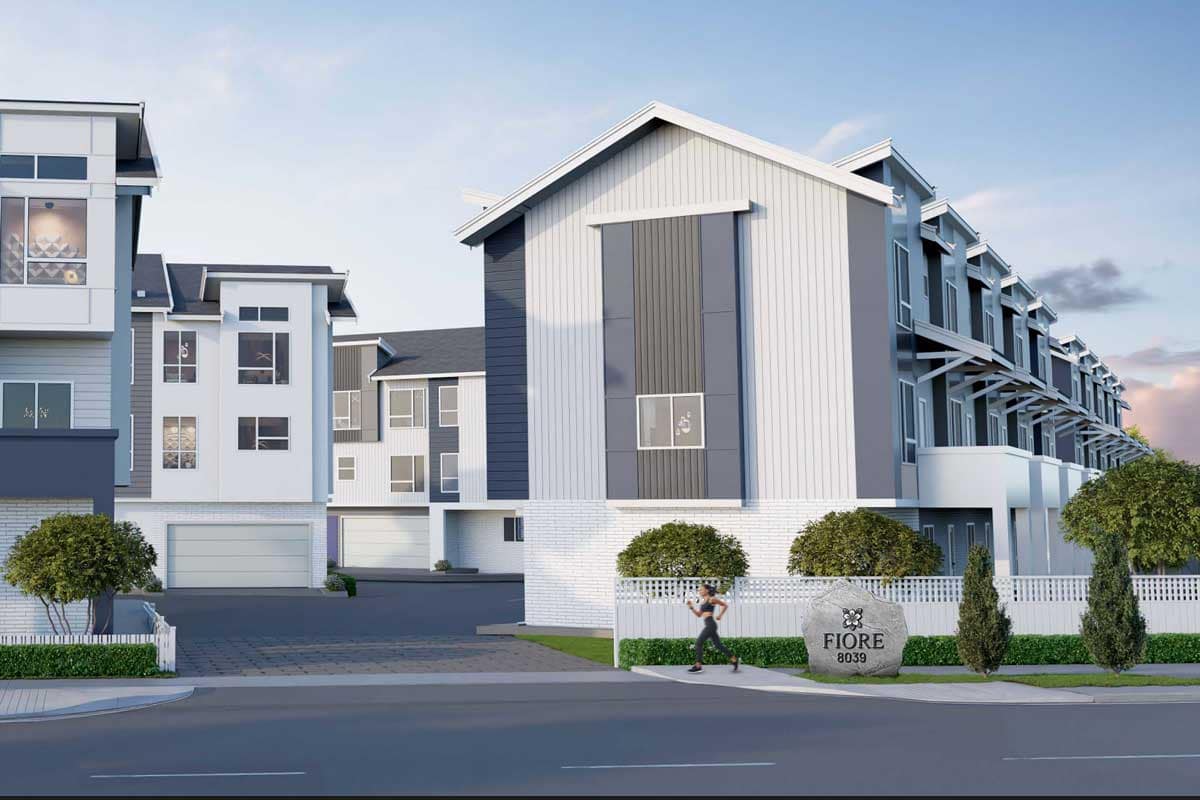 Street-level exterior rendering of Fiore Langley by Front Lane Developments at 8039 197 Street, featuring contemporary townhome architecture, landscaped walkways, modern facades, garage entrances, and the Fiore community entrance signage in Langley.