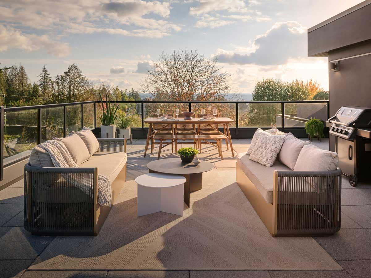 Modern rooftop patio at Langley presale condos featuring outdoor seating, dining area, and sunset views, highlighting lifestyle amenities in new construction homes.