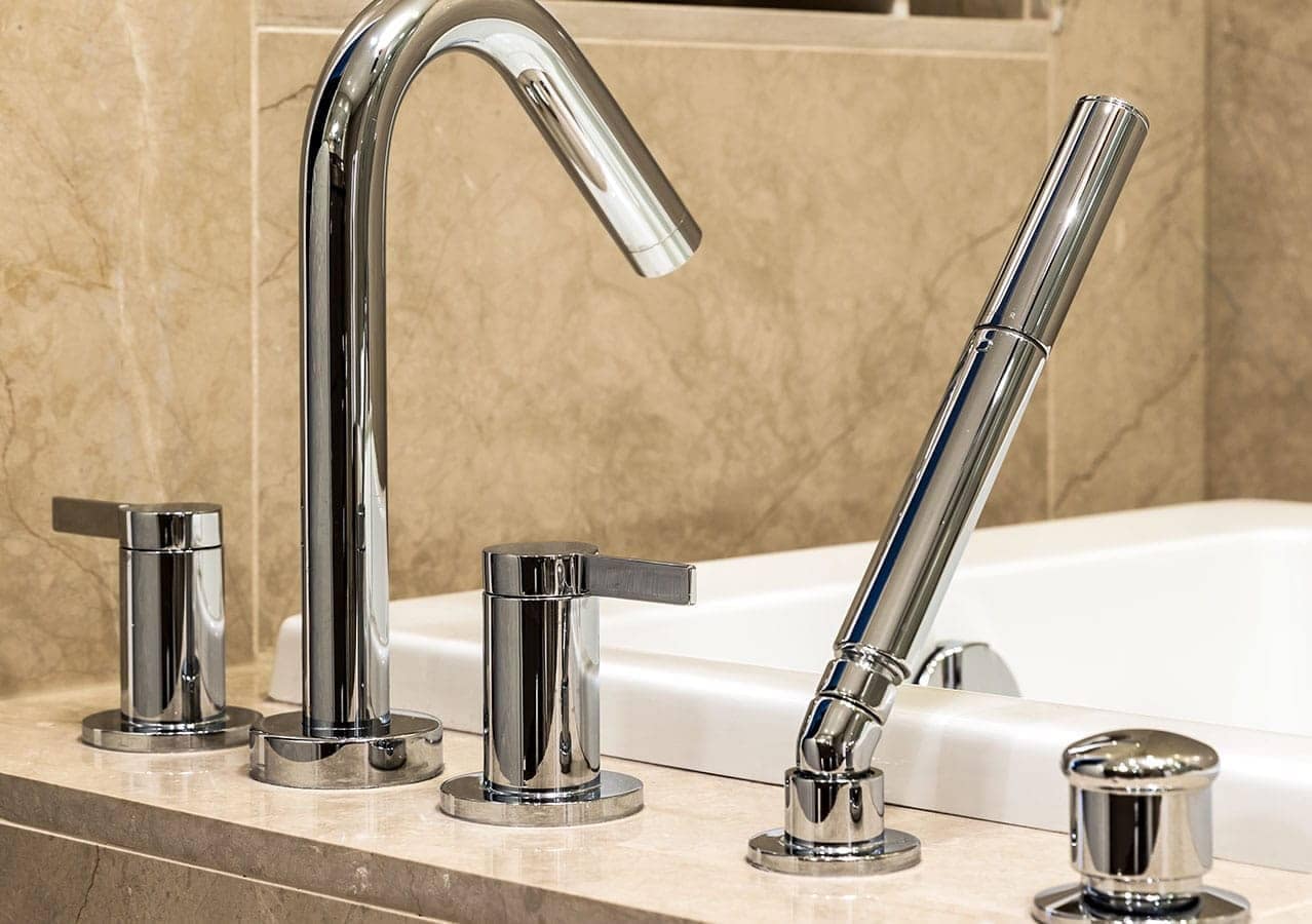 Close-up of polished chrome bathroom fixtures and countertop finishes at 1535 Howe Vancouver by Onni located at 1335 Howe Street in Downtown Vancouver.